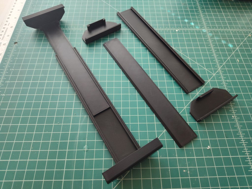 3D-Printed t-shirt wall mounts laid out