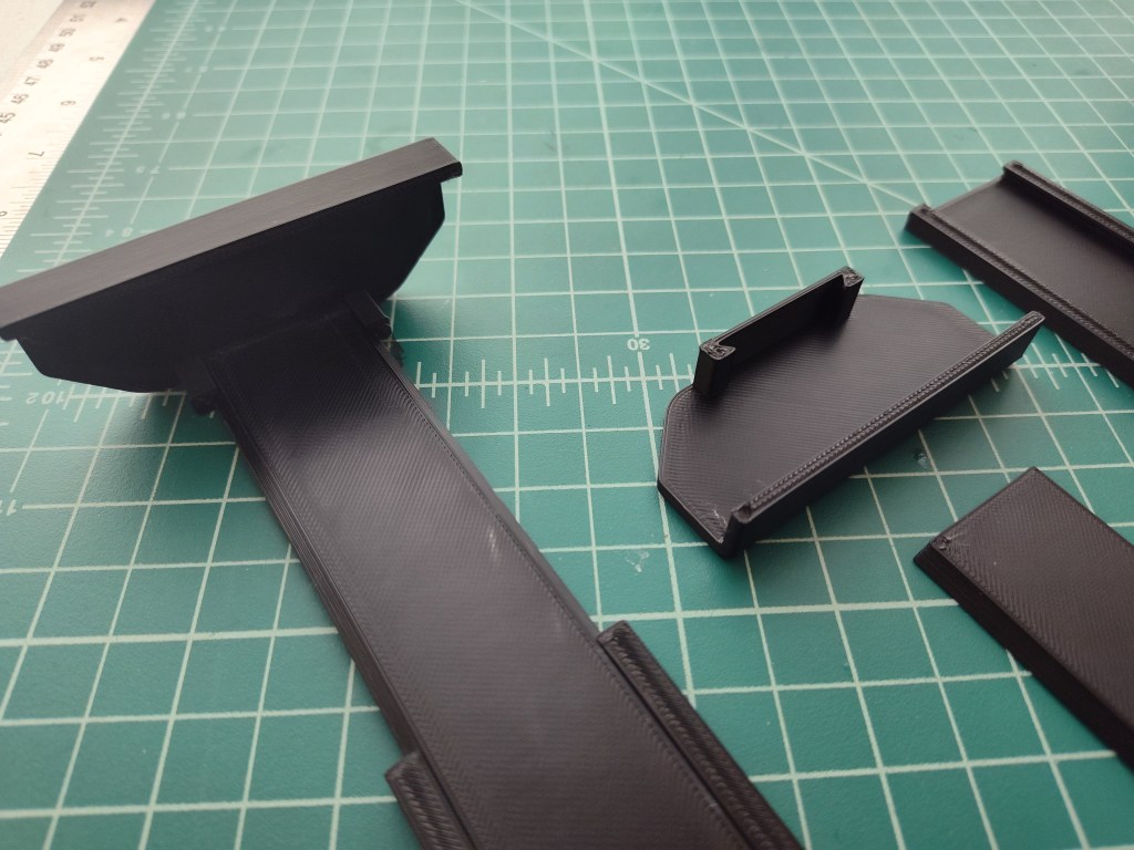 bottom part of the 3D-Printed t-shirt wall mounts laid out