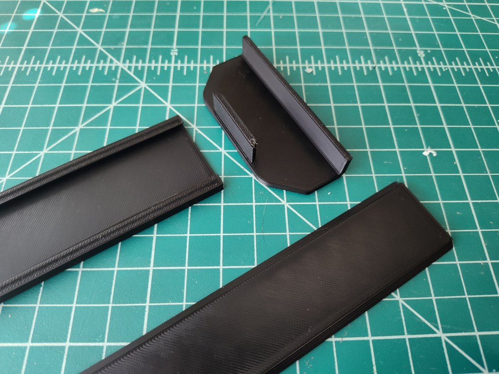 top part of the 3D-Printed t-shirt wall mounts laid out